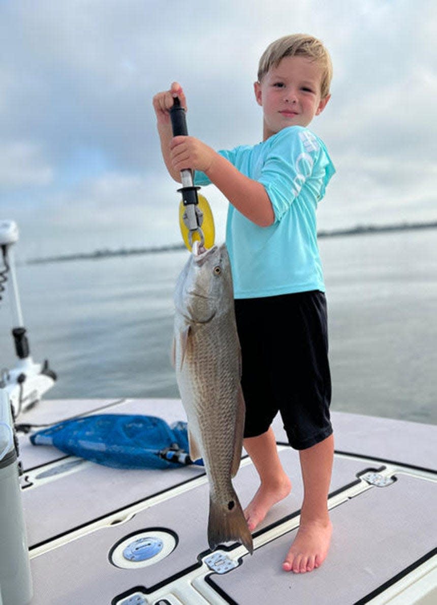 Four-year-old Lane Patrou caught this pretty redfish and several more, fishing with his grandad, guide Todd Thompson, last week.