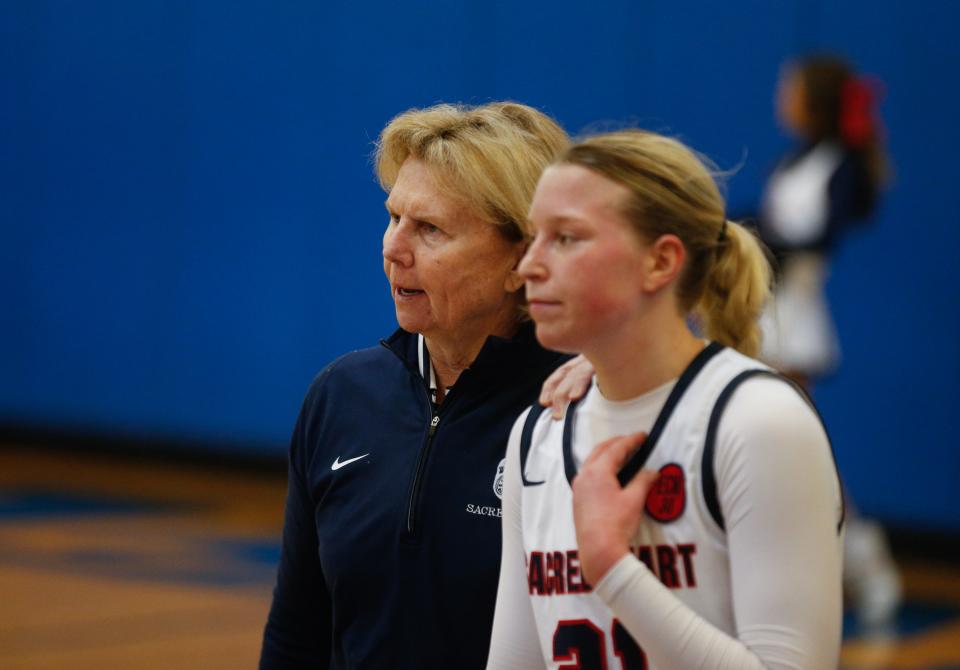 Sacred Heart coach Donna Moir talks to senior Reagan Bender. Bender scored 21 points in the Valkyries' LIT semifinal victory Saturday against Cooper.