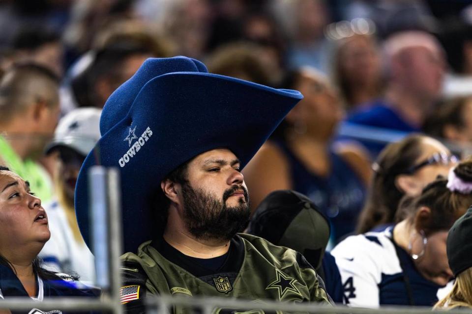 A fan wears a large foam Dallas Cowboys hat while watching a preseason game against the Las Vegas Raiders at AT&T Stadium in Arlington, Texas on Saturday, Aug. 26, 2023.