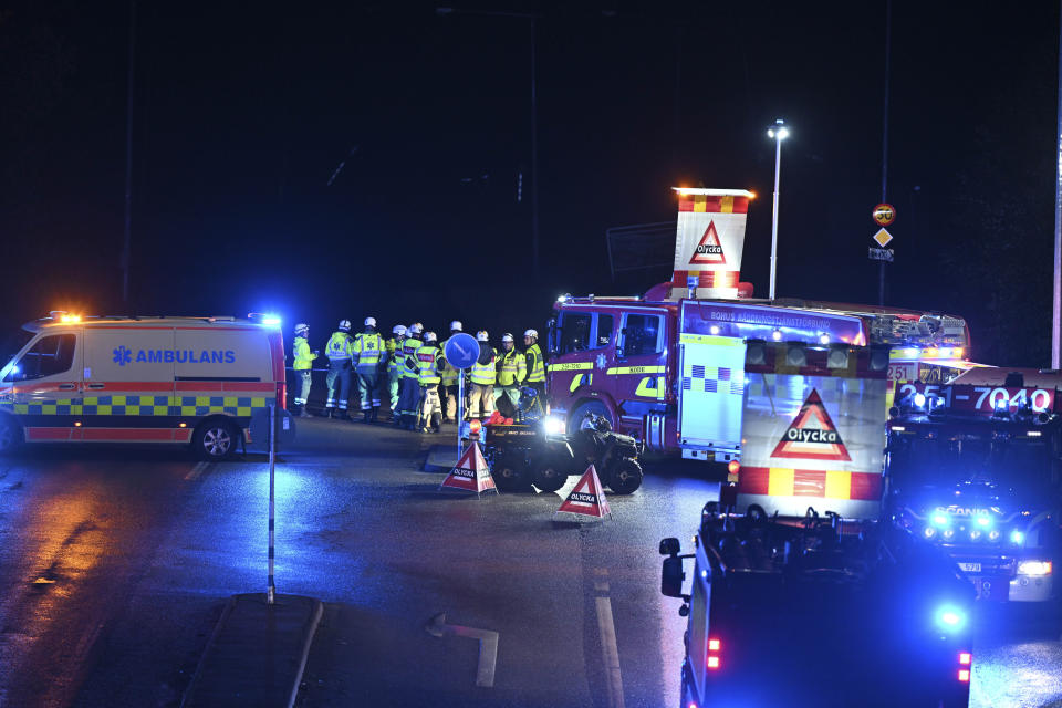 A view of emergency services on the E6 near Stenungsund, closed in both directions after persistent rain caused a landslide, in Stenungsund, Saturday, Sept. 23, 2023. Three people have been injured and several buildings and vehicles damaged after a highway collapsed following a landslide in western Sweden early Saturday.Photos and video footage showed a huge sinkhole that had opened on the E6 highway, which runs from southern Sweden to Norway, not far from Sweden’s second largest city of Goteborg. (Björn Larsson Rosvall/TT News Agency via AP)