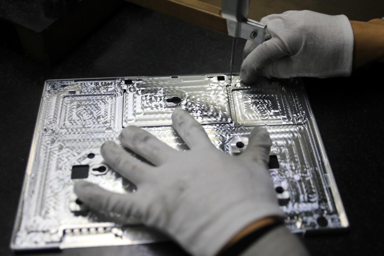 A worker checking laptop parts at a Chinese semiconductor factory  (AFP via Getty Images)