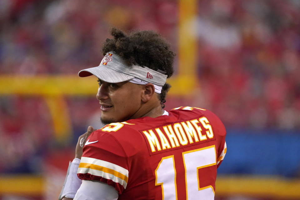Kansas City Chiefs quarterback Patrick Mahomes watches from the sidelines during the first half of an NFL football game against the Minnesota Vikings Friday, Aug. 27, 2021, in Kansas City, Mo. (AP Photo/Ed Zurga)