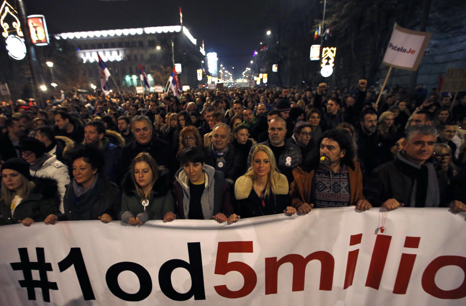 People hold a banner that reads: ''#1out of 5 million'' during a protest against populist President Aleksandar Vucic in Belgrade, Serbia, Saturday, Dec. 22, 2018. Thousands of people have rallied in another protest in Serbia against populist President Aleksandar Vucic accusing him of stifling hard-won democratic freedoms and cracking down on opponents. (AP Photo/Darko Vojinovic)