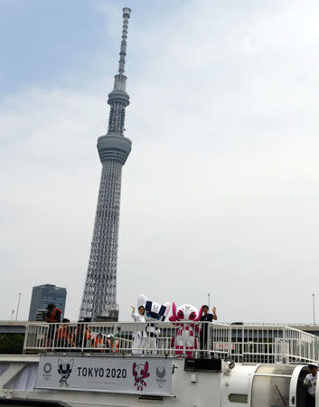 Tokyo 2020 Olympics Games mascots, Miraitowa and Someity ride on a boat starting their debut event of water parade in front of the Tokyo Skytree with karate player Kiyo Shimizu and para-athlete Hajimu Ashida in Tokyo, Japan July 22, 2018. Toshifumi Kitamura/Pool via Reuters