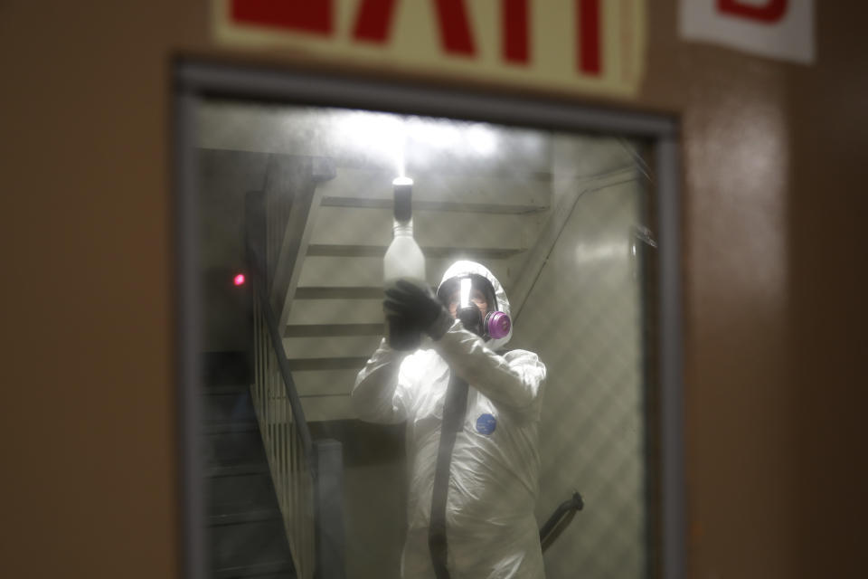 Safety Director Tony Barzelatto sprays disinfectant in a stairwell in Co-op City in the Bronx borough of New York, Wednesday, May 13, 2020. Regular cleanings occur throughout the common areas of the buildings while the heavy disinfecting occurs in response to specific incidents, in this case reports of two coronavirus cases on the same floor. Within the Bronx, almost no place has been hit as hard as Co-op City. (AP Photo/Seth Wenig)