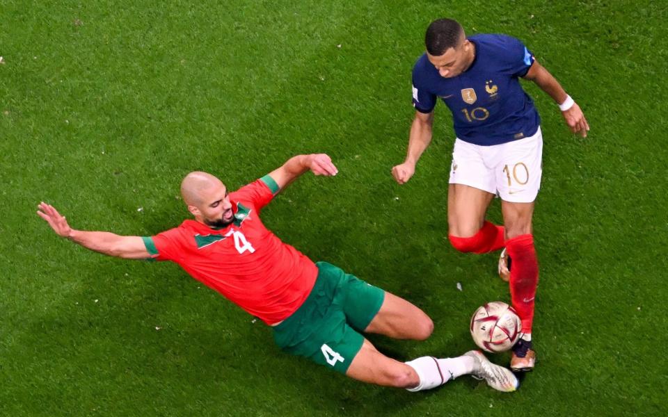 Sofyan Amrabat tackles Kylian Mbappe - Antonin Thuillier/AFP