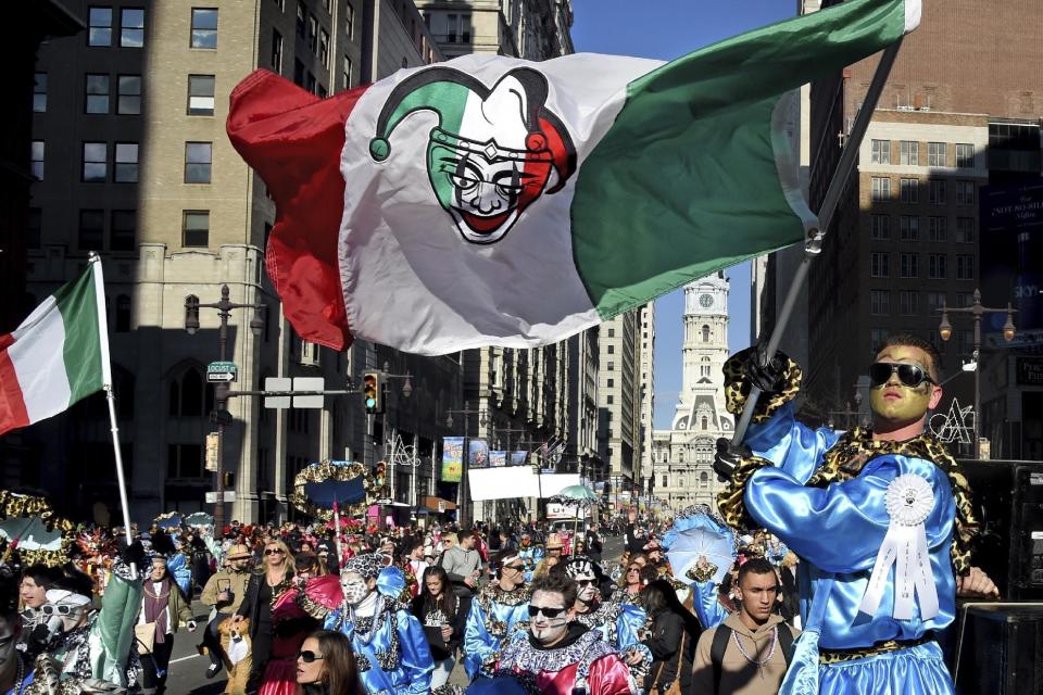 John Righi, 21, of South Philadelphia waves the Jesters flag as his comics move down Broad Street during the 2017 Mummers Parade, Sunday, Jan. 1, 2017, in Philadelphia. (Tom Gralishu/The Philadelphia Inquirer via AP)