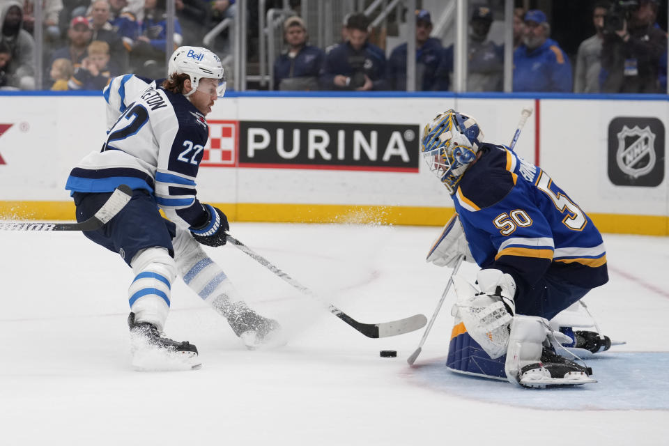 Winnipeg Jets' Mason Appleton (22) is unable to score past St. Louis Blues goaltender Jordan Binnington during the third period of an NHL hockey game Tuesday, Nov. 7, 2023, in St. Louis. (AP Photo/Jeff Roberson)