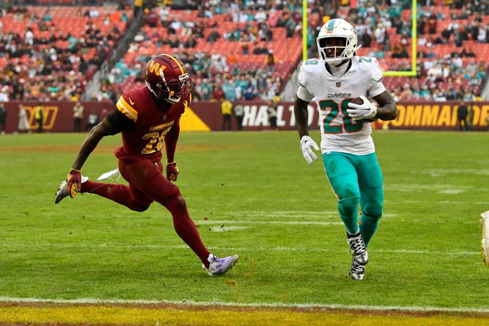 Dolphins running back De'Von Achane scores one of his two touchdowns against Washington.