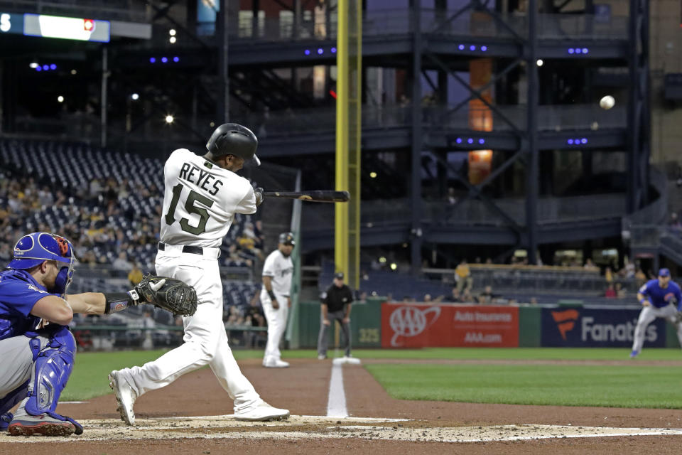 Pittsburgh Pirates' Pablo Reyes (15) drives in two runs with a triple off Chicago Cubs starting pitcher Jose Quintana during the first inning of a baseball game in Pittsburgh, Thursday, Sept. 26, 2019. (AP Photo/Gene J. Puskar)