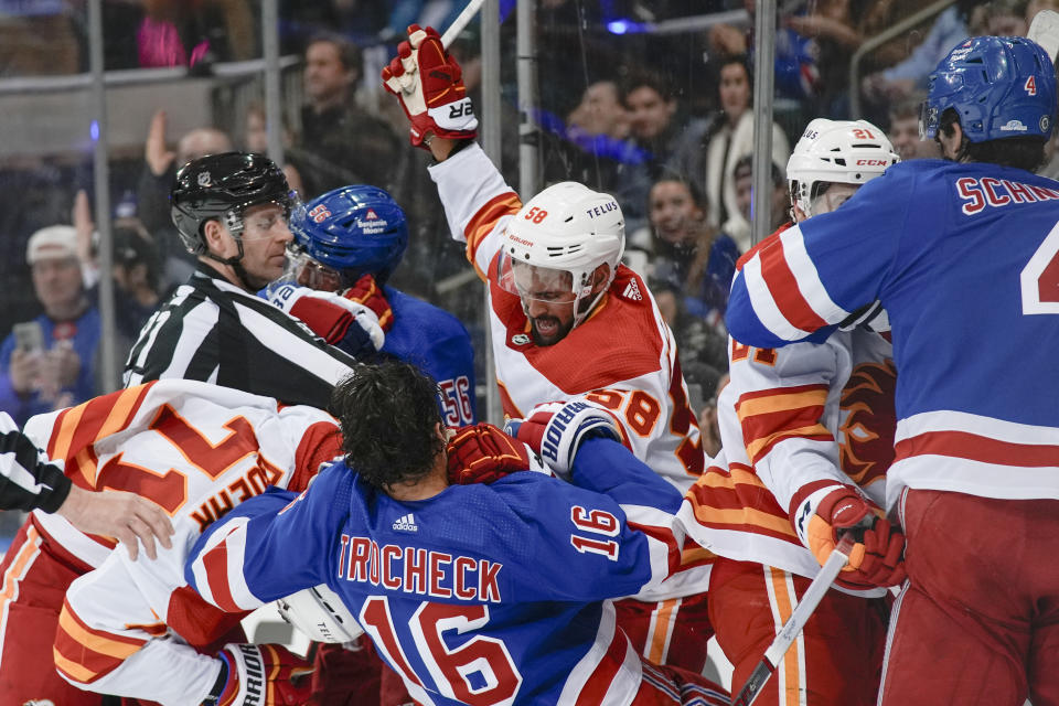 Players fight during the second period an NHL hockey game between the New York Rangers and the Calgary Flames on Monday, Feb. 12, 2024, in New York. (AP Photo/Bryan Woolston)