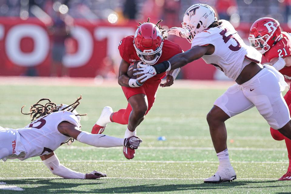 Sep 16, 2023; Piscataway, New Jersey, USA; Rutgers Scarlet Knights quarterback Gavin Wimsatt (2) is tackled by Virginia Tech Hokies safety Jalen Stroman (26) and defensive lineman Antwaun Powell-Ryland (52) during the first half at SHI Stadium. Mandatory Credit: Vincent Carchietta-USA TODAY Sports