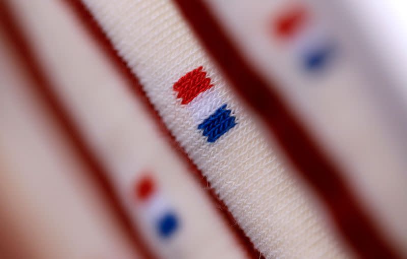 FILE PHOTO: French flag is seen on a pair of socks displayed at the "Made In France" fair in Paris