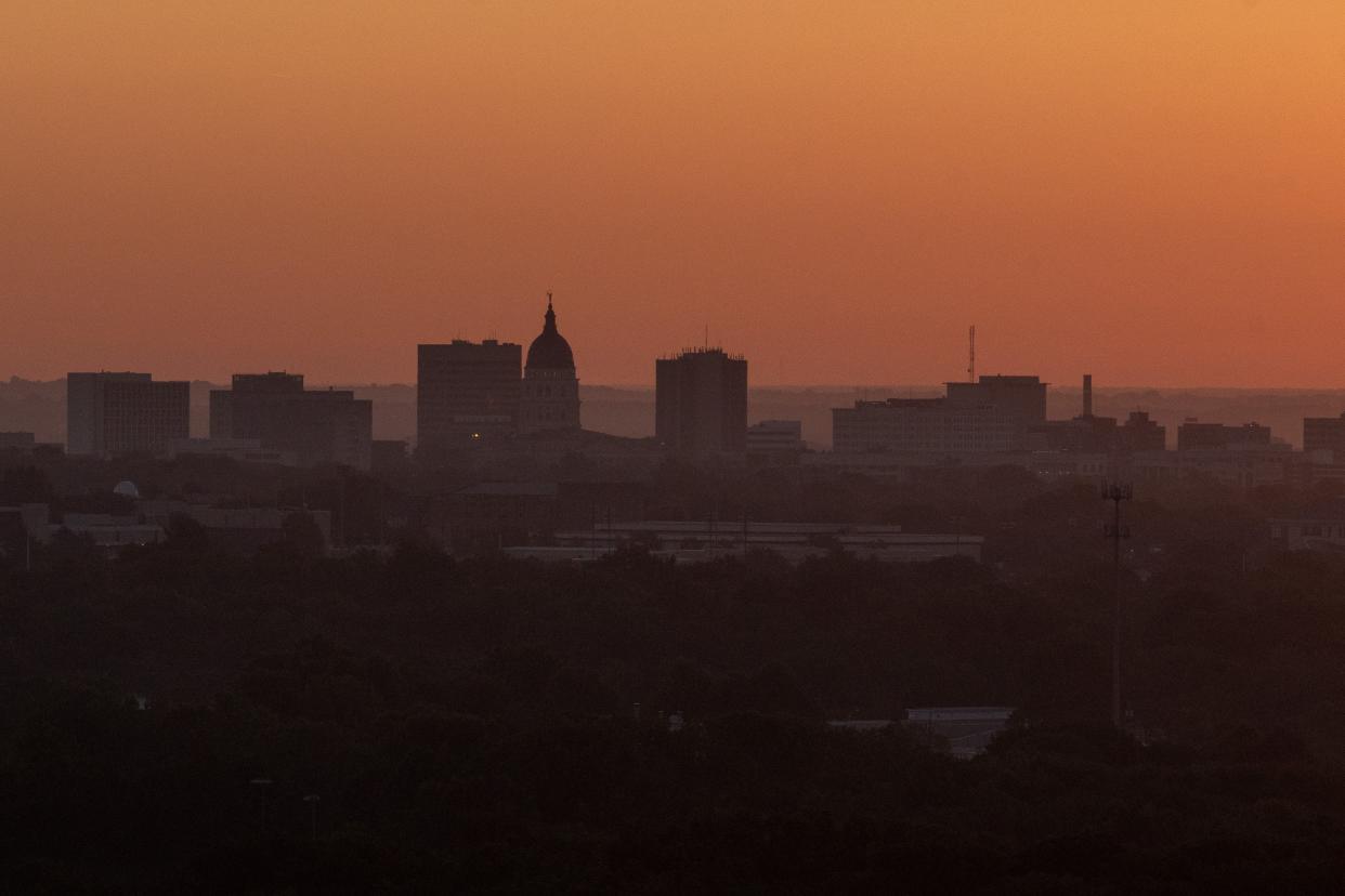 The sun rises over downtown Topeka as seen from the top of Burnett's Mound. The annual observance of Daylight Saving Time, which begins at 2 a.m. Sunday, is aimed at making better use of sunlight.