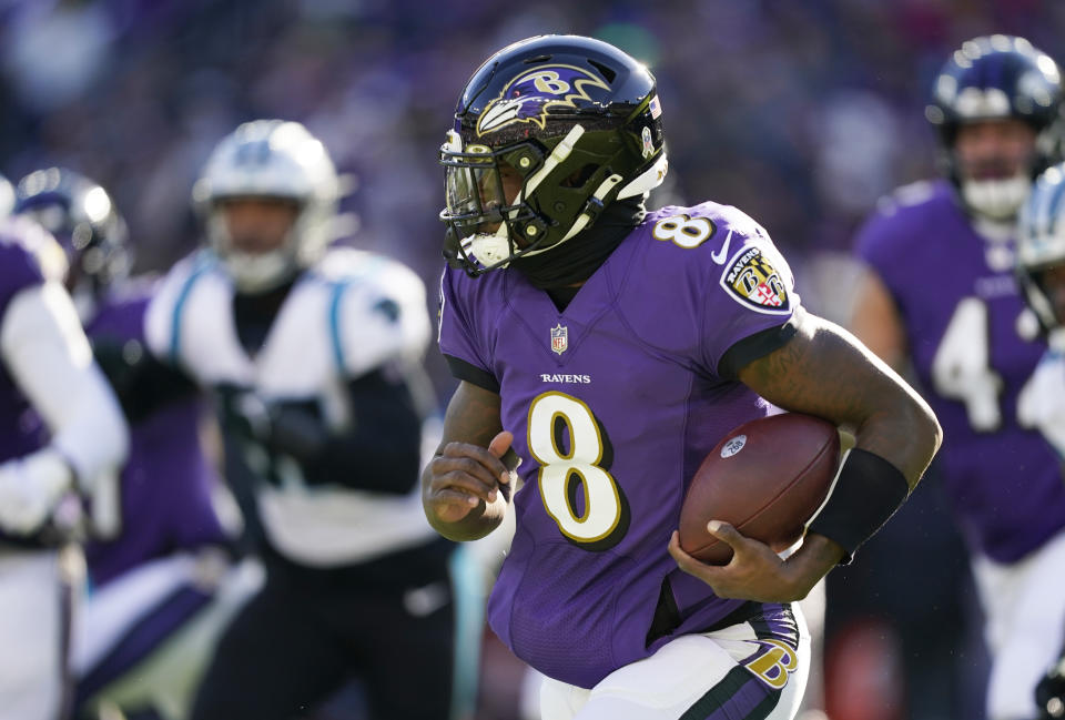 Baltimore Ravens quarterback Lamar Jackson (8) looks for running room in the first half of an NFL football game against the Carolina Panthers Sunday, Nov. 20, 2022, in Baltimore. (AP Photo/Patrick Semansky)