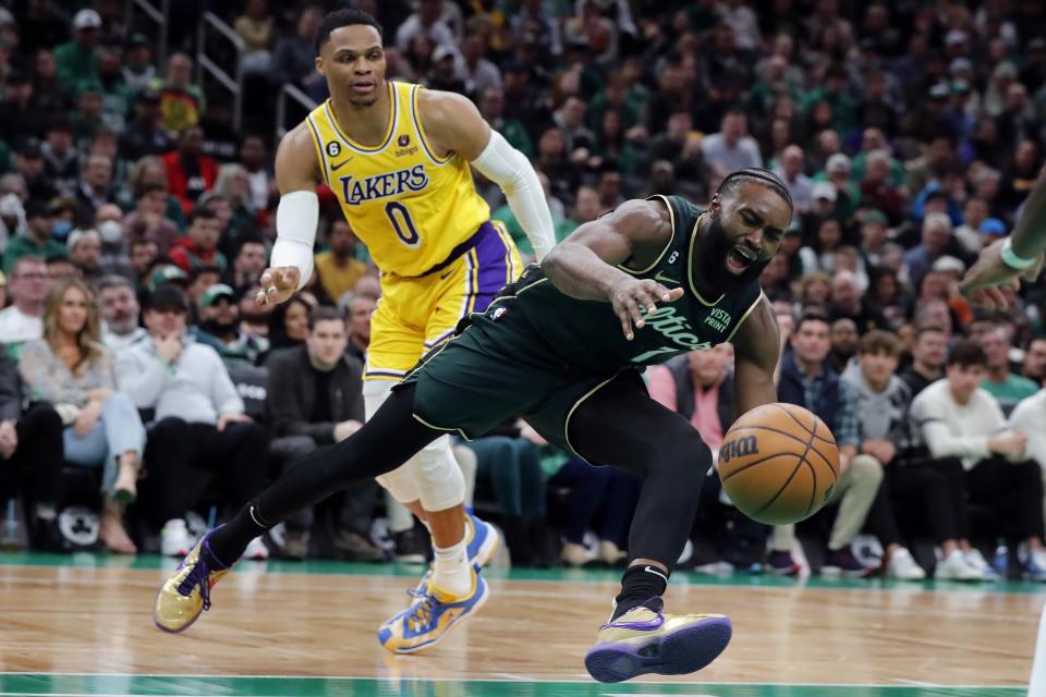 Boston Celtics' Jaylen Brown (7) looses control of the ball in front of Los Angeles Lakers' Russell Westbrook (0) during the first half of an NBA basketball game, Saturday, Jan. 28, 2023, in Boston. (AP Photo/Michael Dwyer)