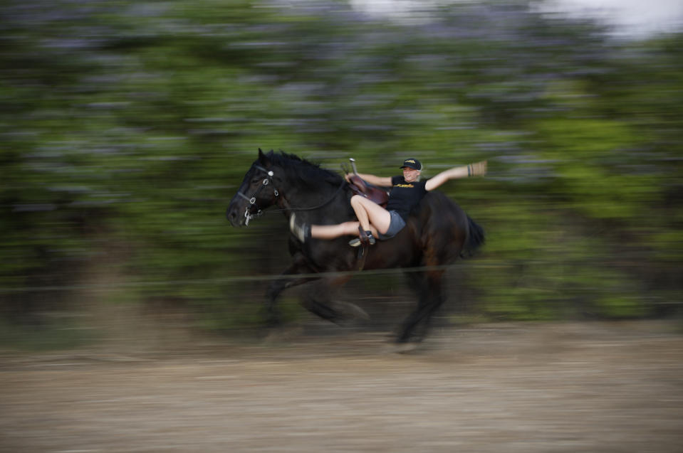 Ariel Hold practices a routine on a horse for "Gladius The Show," a touring equestrian and acrobatic show, Thursday, May 28, 2020, in Las Vegas. The coronavirus forced the producers to cancel all of their performances through 2020. (AP Photo/John Locher)