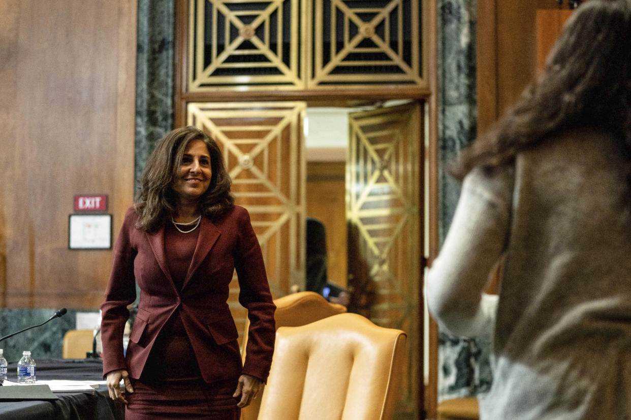 Neera Tanden, President Joe Biden's nominee for Director of the Office of Management and Budget (OMB), looks to her daughter at the end of a hearing before a Senate Committee on the Budget hearing on Capitol Hill in Washington, Wednesday, Feb. 10, 2021. (Anna Moneymaker/The New York Times via AP, Pool)