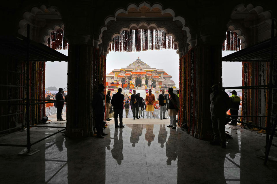 People arrive ahead of the inauguration of the temple of the Hindu god Ram in Ayodhya, northern Uttar Pradesh state, India, Monday, Jan.22, 2024. The magnificent temple lies at the site of a 16th-century mosque that was destroyed by a Hindu mob in December 1992, sparking massive Hindu-Muslim violence. (AP Photo/Rajesh Kumar Singh)