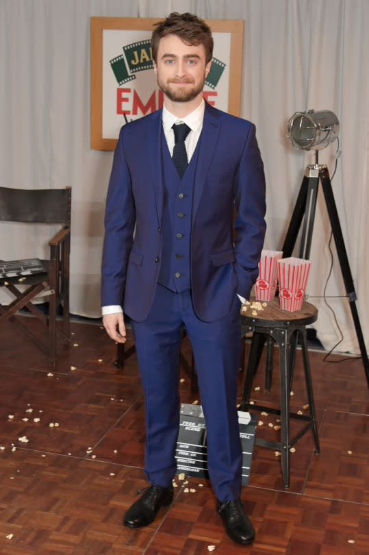 <p>Dan Rad looks pretty Damn Rad in this bright blue, three-piece suit—a sharp update from that dowdy cape he used to wear all the time. The dark knitted and simple shoes modernize the whole look, making it all the more magical. <i>(Photo: Getty)</i></p>