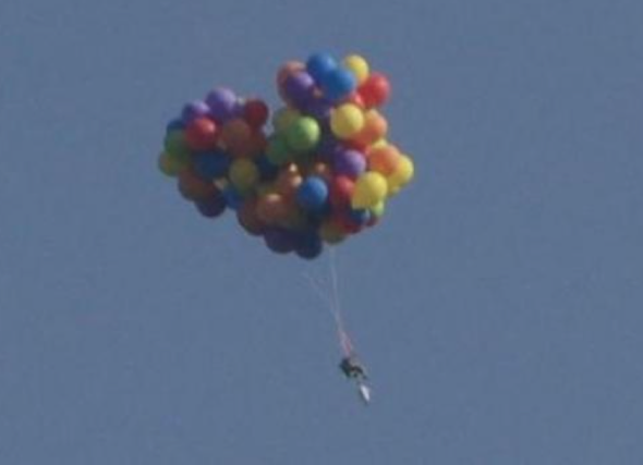 Man arrested for flight in chair attached to balloons (video)