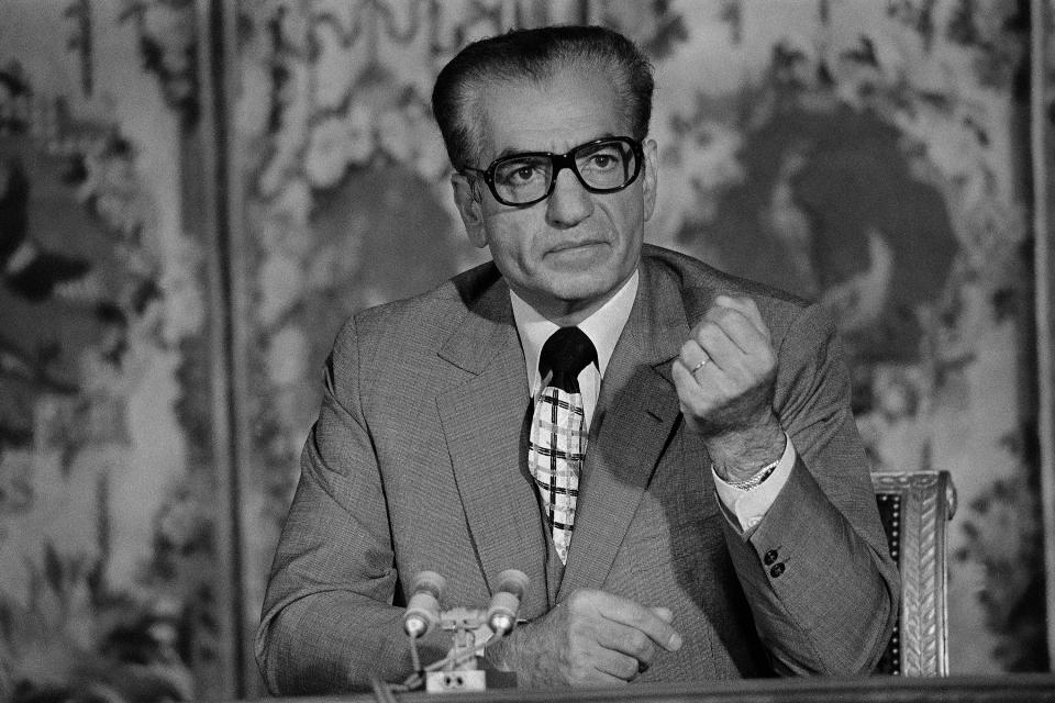 FILE - In this June 27, 1974 file photo, the Shah of Iran, Mohammad Reza Pahlavi, gestures during a press conference at the Trianon in Versailles, near Paris, France. The fall of the Peacock Throne and the rise of the Islamic Revolution in Iran grew out of the shah’s ever-tightening control over the country as other Middle East monarchies toppled. Instead of fighting and holding onto power, the shah instead chose exile 40 years ago, flying away on a jetliner that he himself piloted. (AP Photo, File)