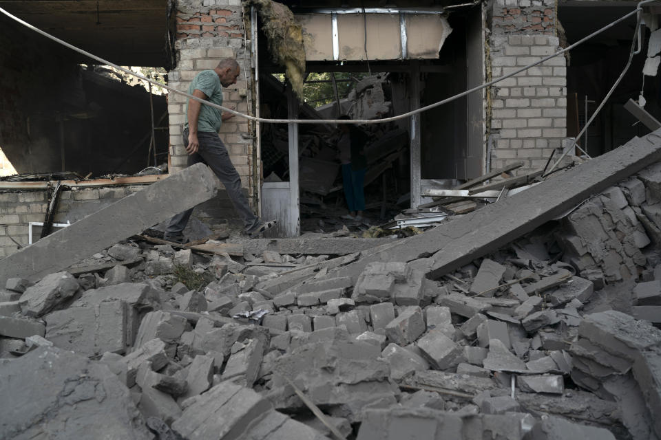 FILE - A man walks over debris of a psychiatric hospital that was heavily damaged after a Russian attack in Kramatorsk, Ukraine, Sept. 7, 2022. In December, the World Health Organization said one in five people in countries that have experienced conflict in the past decade will suffer from a mental health condition, and estimated that about 9.6 million people in Ukraine could be affected. Russia’s invasion in February 2022 resulted in millions of people being displaced, bereaved, forced into basements for months due to incessant shelling or enduring harrowing journeys from Russian-occupied regions. (AP Photo/Leo Correa, File)