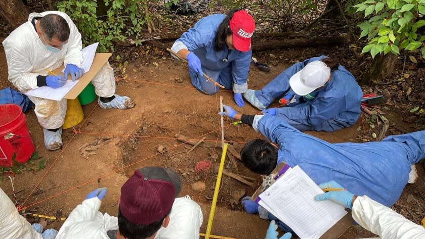 Mexican forensic officials practice excavating a grave at the University of Tennessee's Forensic Anthropology Center.