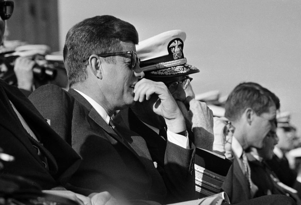 President John F. Kennedy, attending the 63rd Army-Nanvy football game at Philadelphia Stadium on December 1, 1962, watched the action on the field. Seated at the far right is the president's brother, Robert Kennedy. The president spent one-half on the Navy side and one-half on the Army side.