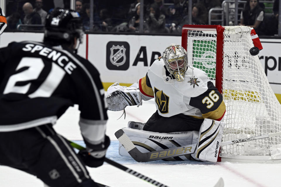 Vegas Golden Knights goaltender Logan Thompson (36) deflects a shot by Los Angeles Kings defenseman Jordan Spence (21) during the second period of an NHL hockey game in Los Angeles, Saturday, Oct. 28, 2023. (AP Photo/Alex Gallardo)