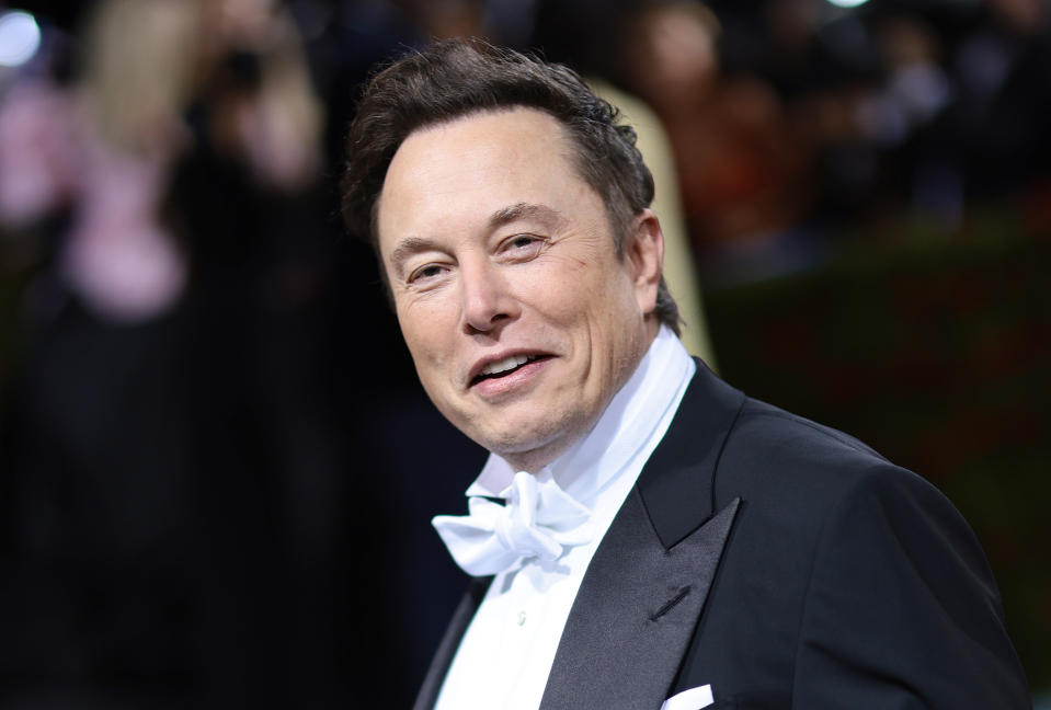 Elon Musk smiling in black tux and white shirt and white bow tie