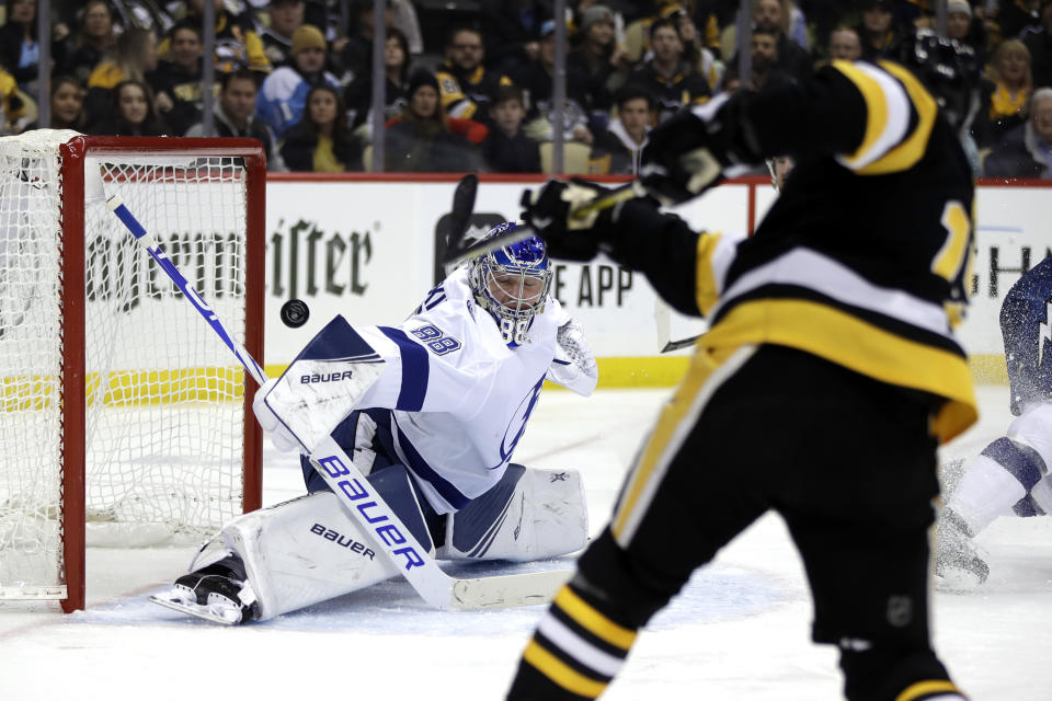 Tampa Bay Lightning goaltender Andrei Vasilevskiy (88) blocks a shot by Pittsburgh Penguins' Bryan Rust during the second period of an NHL hockey game in Pittsburgh, Tuesday, Feb. 11, 2020. (AP Photo/Gene J. Puskar)