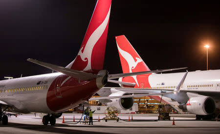Jet fuel is siphoned directly from a Qantas Boeing 747 aircraft (R) acting as a 'fuel mule' to a Boeing 737 (L) on the tarmac of Auckland Airport in New Zealand, September 21, 2017, during fuel shortages which have affected New Zealand's aviation sector. Qantas/Ollie Dale/Handout via REUTERS