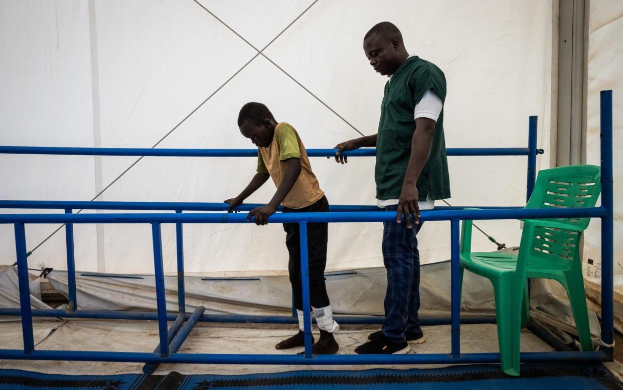 Abdul Latif Bakhit, 10, who was shot in his back in Darfur during the war learns to walk in a clinic run by NGO Handicap International