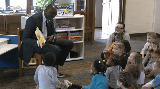 Lt. Gov. Garlin Gilchrist reads to children at Helping Hands Christian Learning Center in Lansing on Wednesday. (WLNS)