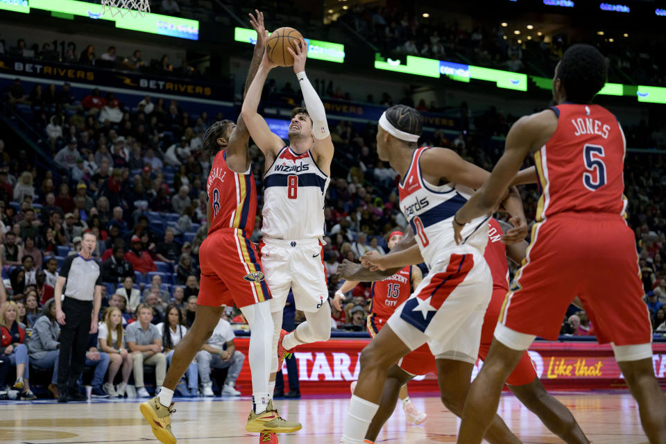 Washington Wizards forward Deni Avdija (8) shoots against New Orleans Pelicans forward Naji Marshall (8) during the second half of an NBA basketball game in New Orleans, Wednesday, Feb. 14, 2024. (AP Photo/Matthew Hinton)