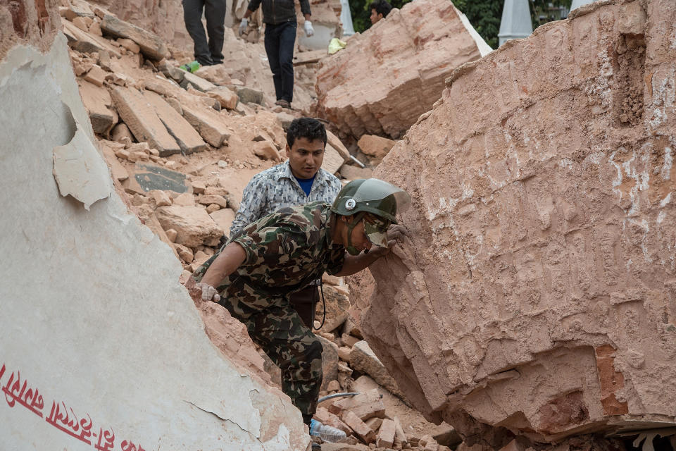 Emergency rescue workers search for survivors in the debris of Dharahara Tower after it collapsed on April 25, 2015 in Kathmandu, Nepal. (Omar Havana/Getty Images)