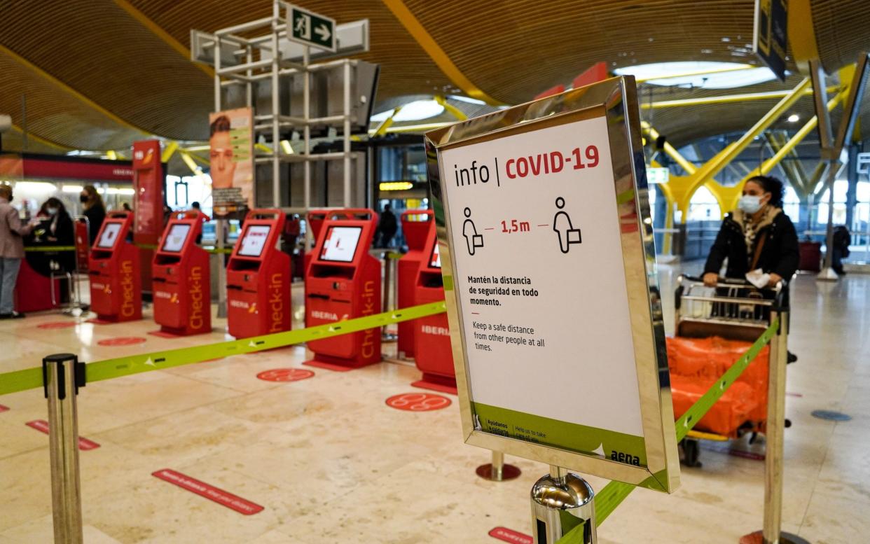 A Covid-19 information sign at the check-in area inside the departures hall at Madrid Barajas airport - Paul Hanna /Bloomberg 