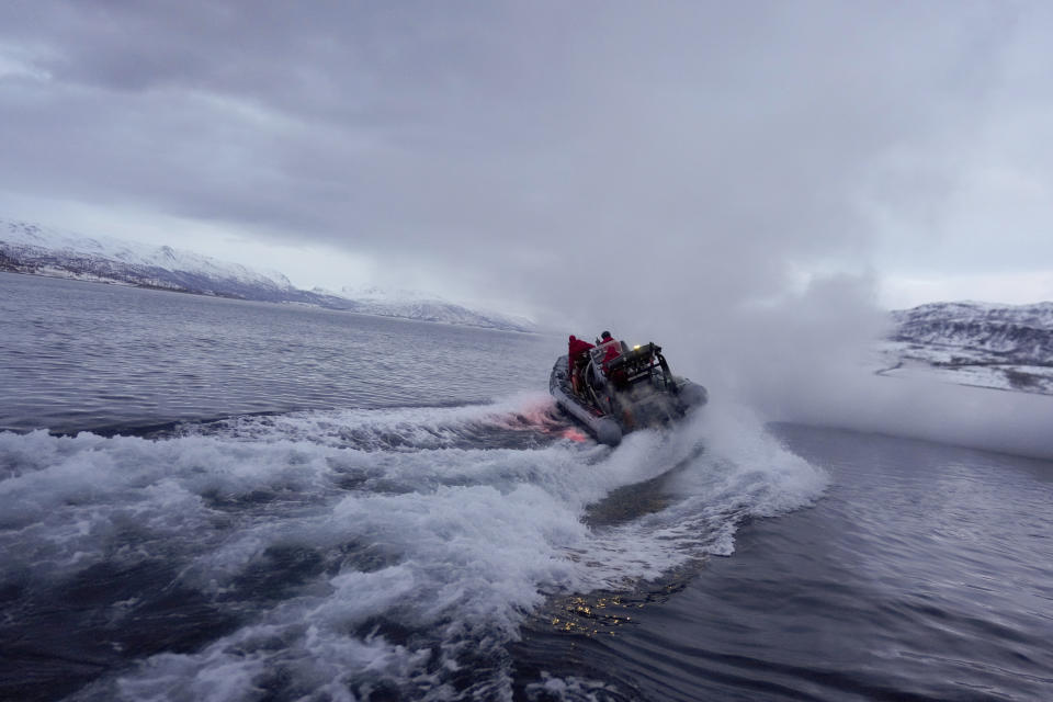 The onboard zodiac of the French navy frigate Normandie sets off from the vessel into a Norwegian fjord, north of the Arctic circle, for a reconnaissance patrol, Wednesday March 6, 2024. (AP Photo/Thibault Camus)