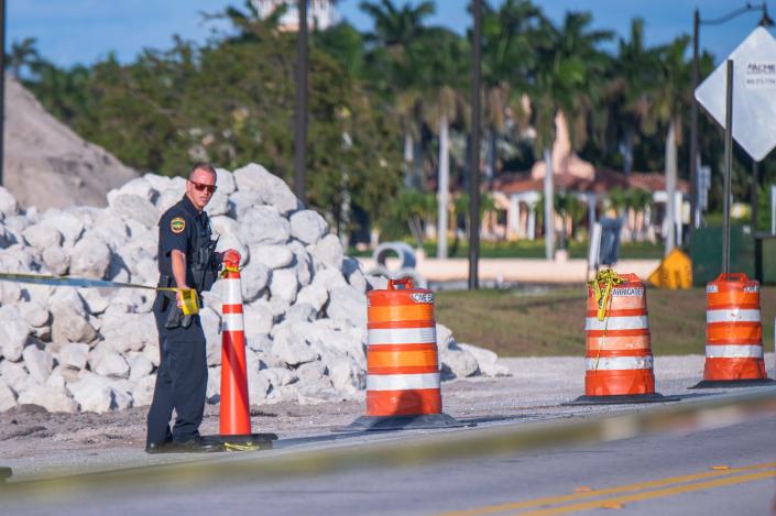 A Palm Beach Police officer ropes off the side of the bridge portion of Southern Boulevard leading to Mar-A-Lago, former President Donald Trump's residence on Thursday, March 30, 2023.