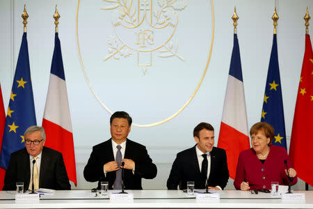 French President Emmanuel Macron, Chinese President Xi Jinping, German Chancellor Angela Merkel and European Commission President Jean-Claude Juncker prepare to hold a news conference at the Elysee presidential palace in Paris, France, March 26, 2019. Thibault Camus/Pool via REUTERS