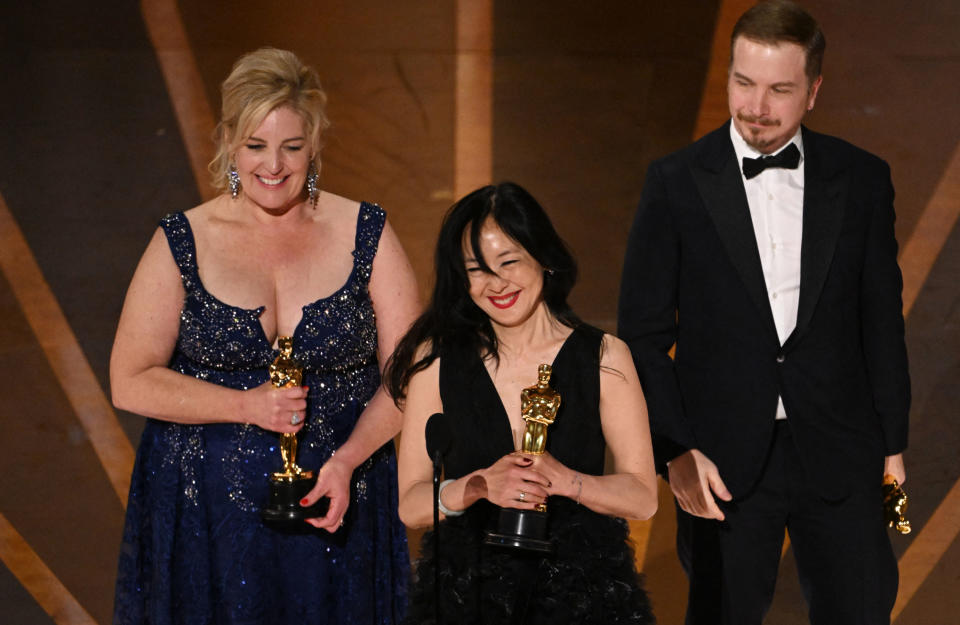 Adrien Morot, Judy Chin, and Annemarie Bradley accept the Academy Award for Best Makeup and Hairstyling for The Whale onstage during the Academy Awards on March 12.