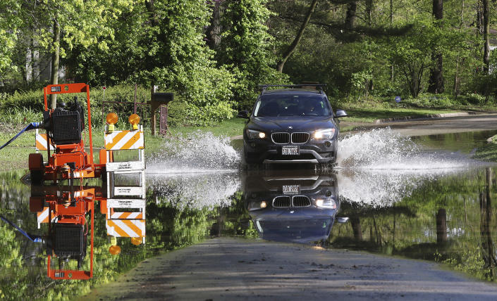 <p>A vehicle drives through flood waters after heavy weekend rains in Lincolnshire, Ill., Monday, May 1, 2017. The governor of Illinois has activated the State Emergency Operations Center as flooding affects parts of the state after heaving weekend rains. (Gilbert R. Boucher II/Daily Herald via AP) </p>