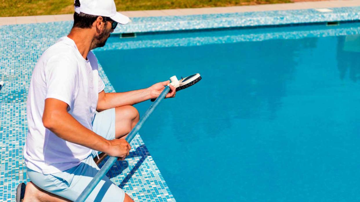 Man cleaning the swimming pool