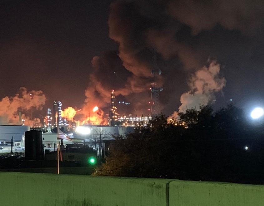 Flames and towers of smoke are seen at ExxonMobil refinery in Baytown, Texas, near Houston, early on December 23, 2021. / Credit: @_mollyfitzz
