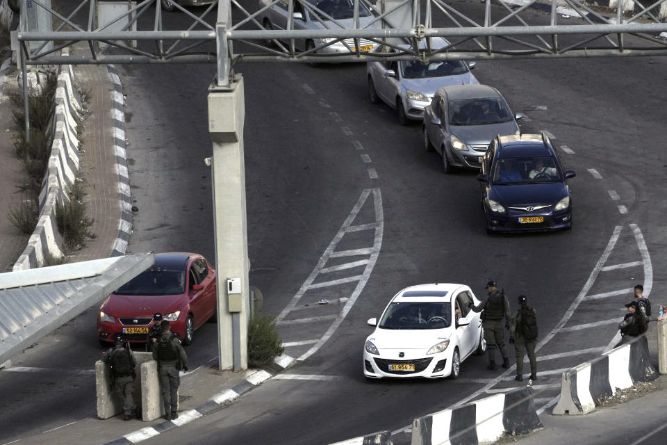 Israeli border police staff a checkpoint at the besieged Shuafat refugee camp in east Jerusalem, Thursday, Oct. 13, 2022. It was the site of fierce clashes after Israeli security forces set up checkpoints that choked off the only exit and entry points of the camp during a manhunt following the death of a soldier, bringing life to a standstill for its estimated 60,000 residents. (AP Photo/Mahmoud Illean)