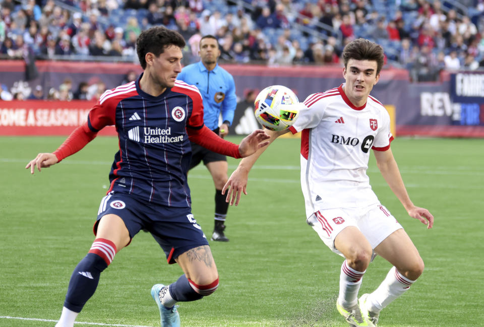 New England Revolution forward Tomas Chancalay, left, and Toronto FC midfielder Alonso Coello, right, chase the ball in the second half of an MLS soccer match, Sunday, March 3, 2024, in Foxborough, Mass. (AP Photo/Mark Stockwell)