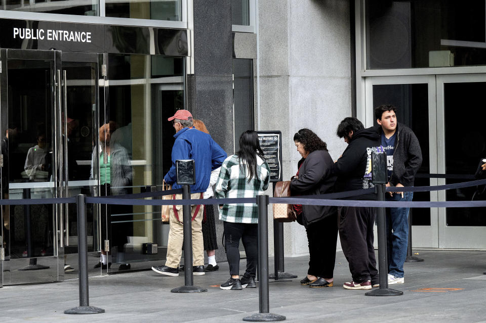 Visitors line up to enter the Phillip Burton Federal Building and U.S. Courthouse where the federal trial of David DePape is underway in San Francisco on Thursday, Nov. 9, 2023. Prosecutors say DePape broke into former House Speaker Nancy Pelosi's home and bludgeoned her husband Paul Pelosi with a hammer in Oct. 2022. (AP Photo/Noah Berger)