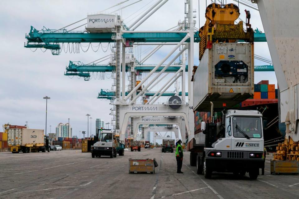 Longshoremen work to offload containers from a cargo ship at PortMiami on Saturday, February 20, 2021.