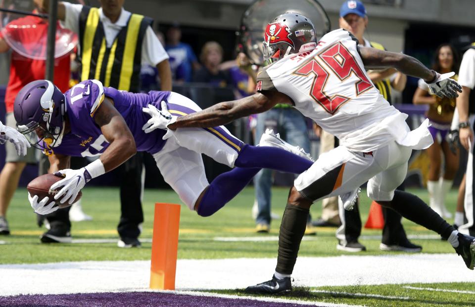 <p>Minnesota Vikings wide receiver Jarius Wright (17) scores on a 2-yard touchdown pass ahead of Tampa Bay Buccaneers cornerback Ryan Smith (29) during the first half of an NFL football game, Sunday, Sept. 24, 2017, in Minneapolis. (AP Photo/Bruce Kluckhohn) </p>